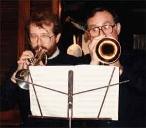 Drs. Scofield and Reichlin perform on their trumpets at a holiday gathering.