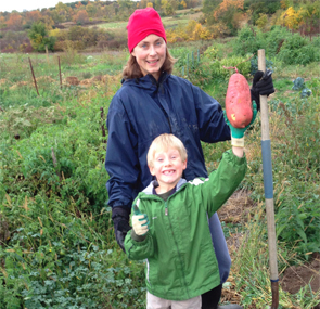 Dr. Kahlenberg and her son, Adyn, enjoy a huge sweet potato harvest.