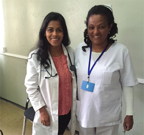 Dr. Abraham (pink shirt) with Nurse Wubitu (head nurse of the Black Lion rheumatology clinic) following her  going-away party.