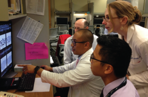 Dr. Lawrence Ho (pulmonary/ILD) points out important features of an HRCT scan to Dr. Greg Gardner (rheumatology), Dr. Percy Balderia (rheumatology fellow) and Dr. Bridget Collins (pulmonary ILD). 