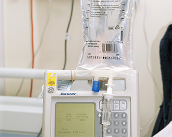 An Intravenous infusion (IV drip) of rituximab is being performed in a hospital setting.