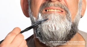 Hair dye being applied to a man’s beard.