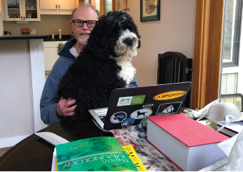 Dr. Albert conducts a telerheumatology with an assist from his “esteemed colleague,” Zeus.