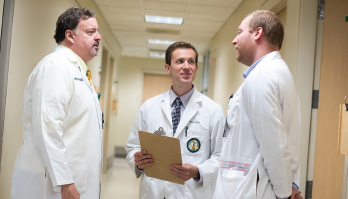 Dr. Bridges converses with colleagues at UAB Medicine.