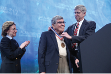 Audrey Uknis, MD, and James O’Dell, MD, present Herbert Kaplan, MD, with the Presidential Gold Medal in 2012.