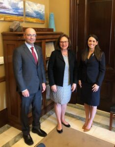 Kent “Kwas” Huston, MD; Sen. Deb Fischer (R-Neb.); and Kaitlyn Brittan, MD, stand in an office.
