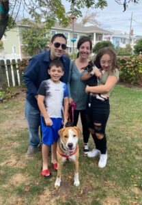 Howard Blumstein stands with family members and two dogs