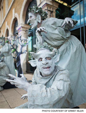 Performers in costume greet EULAR attendees outside of the ExCel convention center in London.