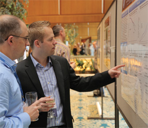 Jeffrey Sparks, MD, MMSc, discusses his poster with Tony Aliprantis, MD, PhD, of Brigham and Women’s Hospital, during the Friday night poster reception.