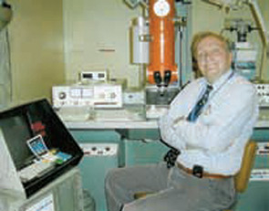 Dr. Schumacher with his electron microscope.