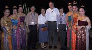 Dr. Schumacher and his wife (center) surrounded by two Thai fellows and six Thai dancers.