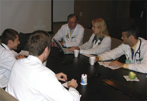 Dr. Sergent (back center) sharing knowledge with some young physicians.