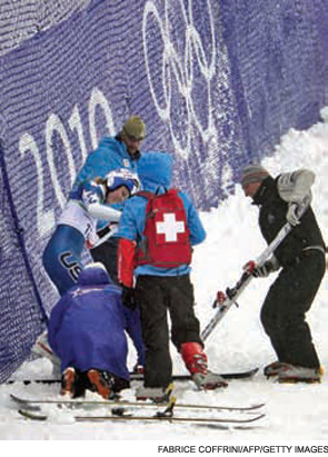 Lindsey Vonn is helped by medics and coaches after crashing during the Women's Vancouver 2010 Winter Olympics giant slalom event.