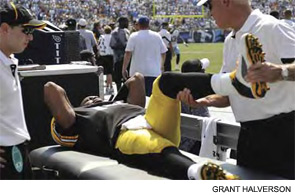Trainers tend to injured quarterback Dennis Dixon of the Pittsburgh Steelers.