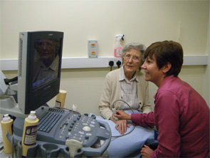 Cornell performs an ultrasound on a patient.