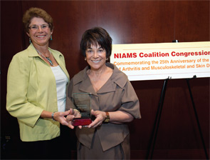 Janet Stearns Wyatt, PhD, RN, CRNP (at left), presents Representative Anna Eshoo (D-CA) with a 2011 NIAMS Coalition Congressional Champion award.