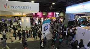 Annual meeting attendees at the Exhibit Hall (top), main staircase, (middle), Poster Hall (bottom), and hospital booths (bottom inset).