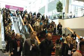 Annual meeting attendees at the Exhibit Hall (top), main staircase, (middle), Poster Hall (bottom), and hospital booths (bottom inset).