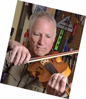 Dr. Higgs playing one of his violins.