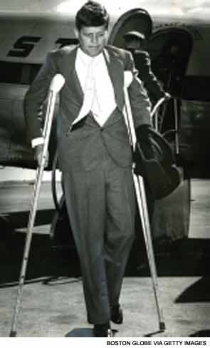 John F. Kennedy using crutches due to back pain.