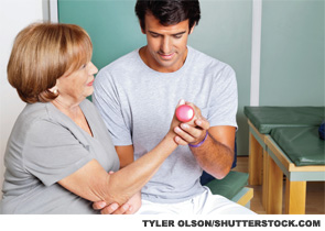A therapist giving muscle training for the elbow joint.